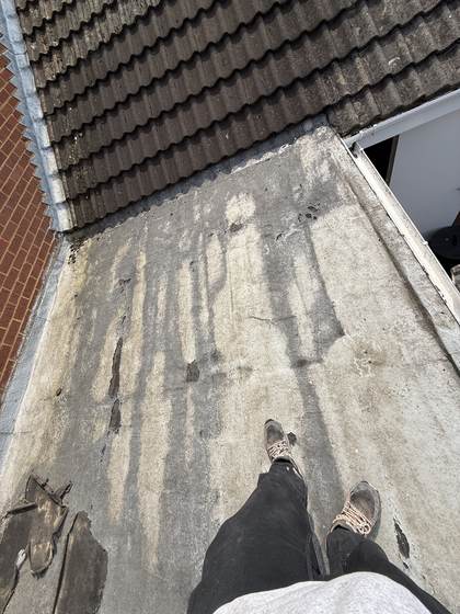 Flat roof beside tiled roof, before