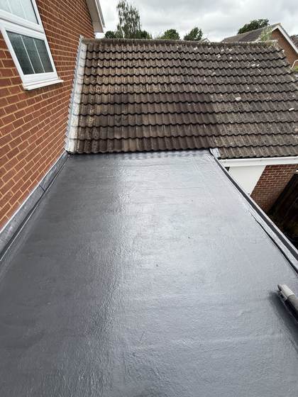Flat roof beside tiled roof, after